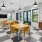 a large room with windows and yellow chairs